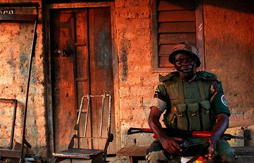 Africa Union peacekeeping soldier takes a strategic position to quell street violence in neighbourhoods in the Central African Republics capital Bangui, on 20 December 2013.